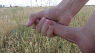 A young guy jerks off in a field and cums far away - porn video